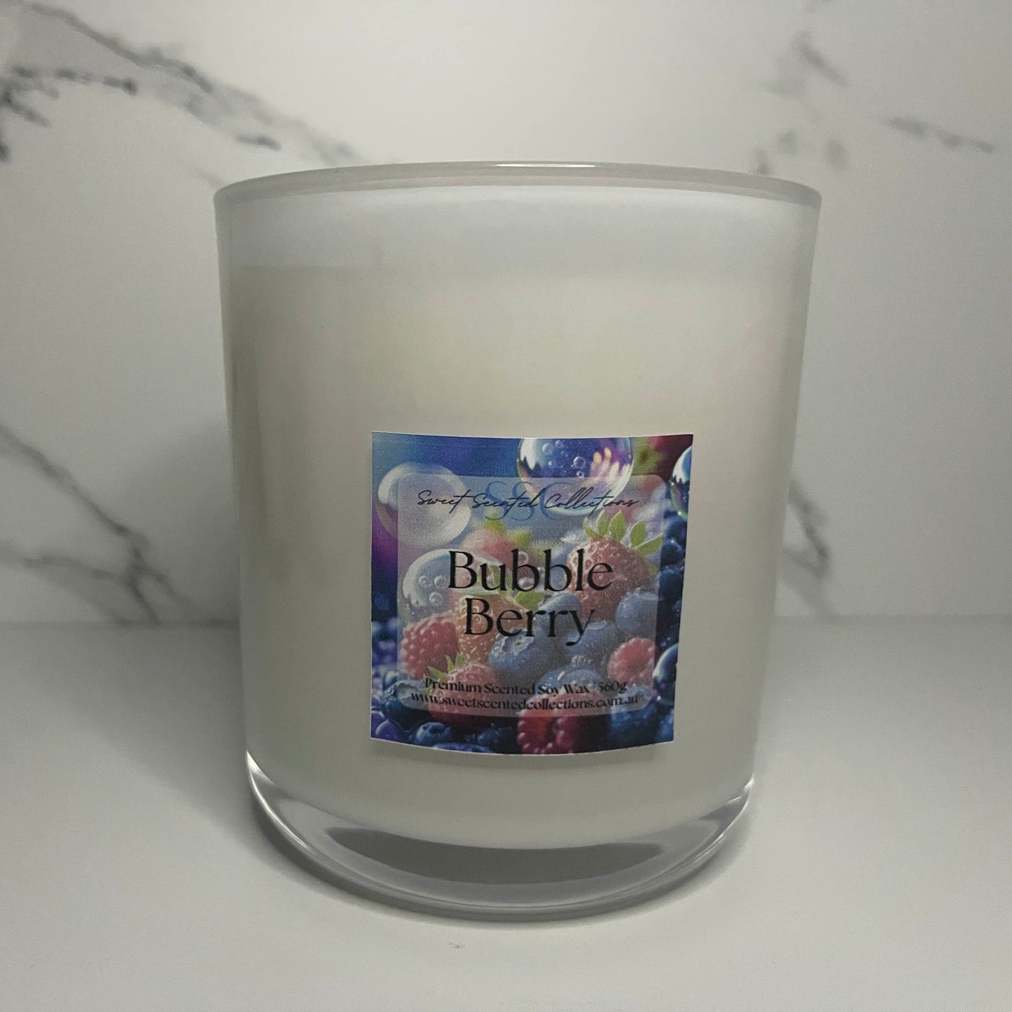 Frosted glass candle with a 'Bubble Berry' label. this is a Scented Soy Wax candle. Scented in bubble berry. this candle is size 560g